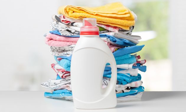 a bottle of fabric freshness and a lot of clothes