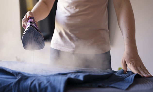 a man ironing his shirt